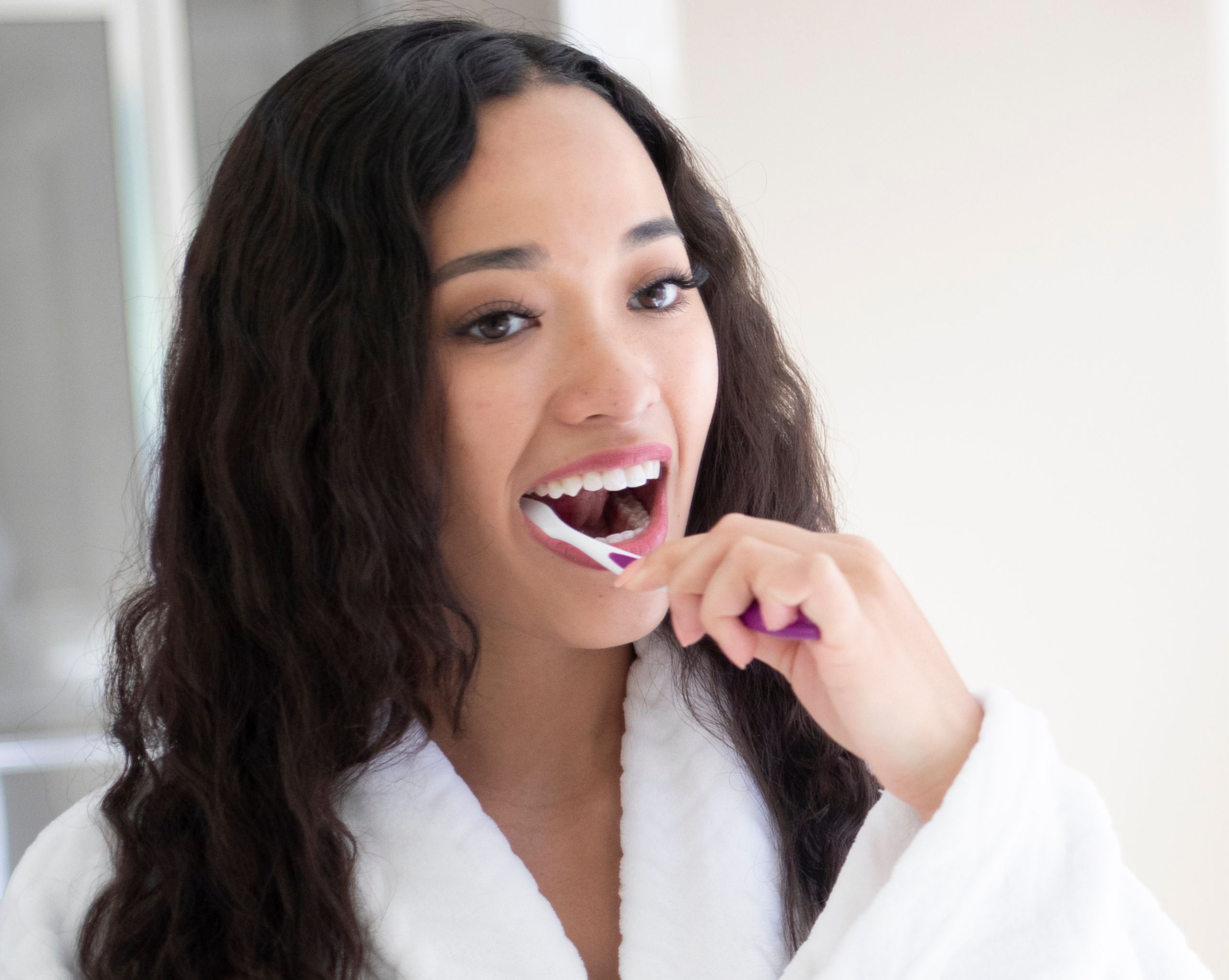 Young woman brushing her teeth