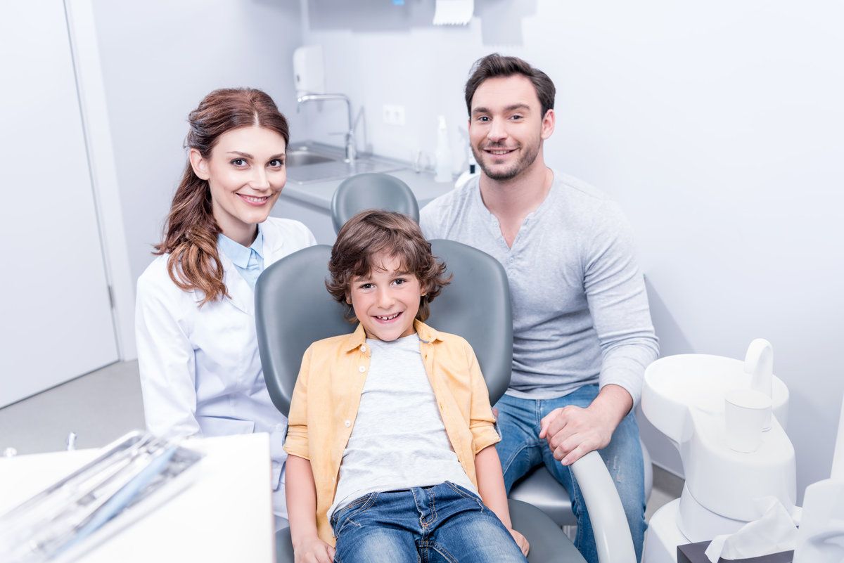Happy family in dental clinic