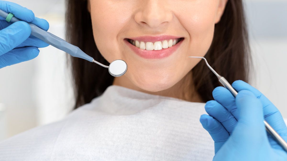 Close up of smiling woman attenting dental clinic